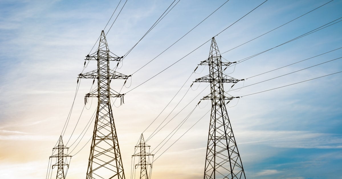 high-voltage power lines against a blue sunset sky, high-voltage transmission tower